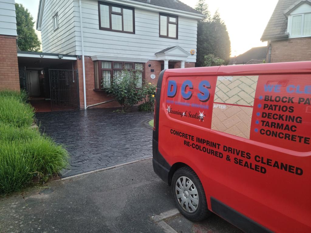 photo of DCS Drive Cleaning Services van, with a concrete imprint drive that has been cleaned in the background